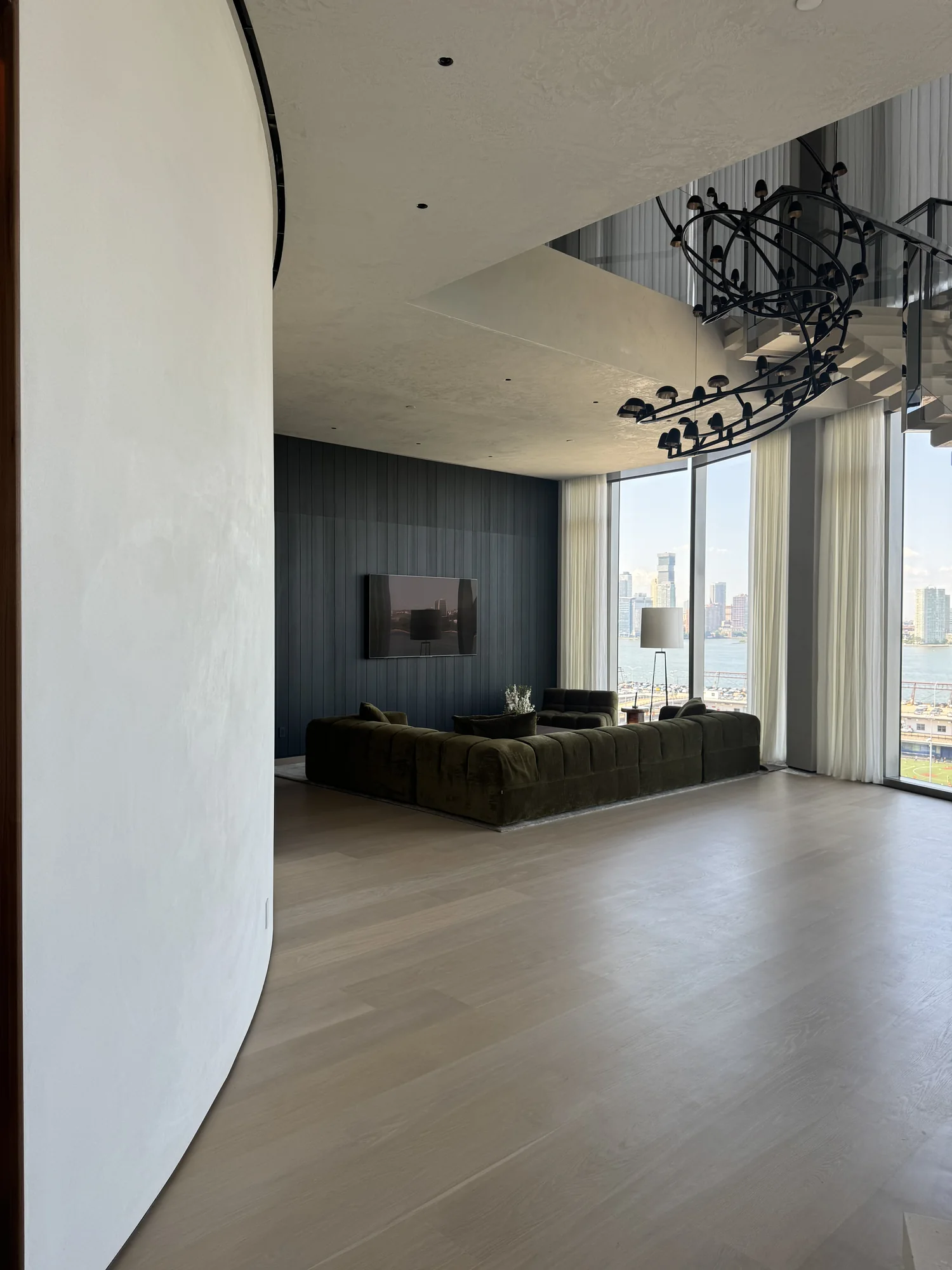 White plaster walls framing a modern high-rise living room
