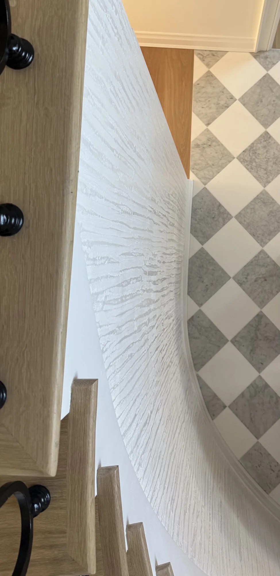 White sculpted plaster beside a geometric stone floor