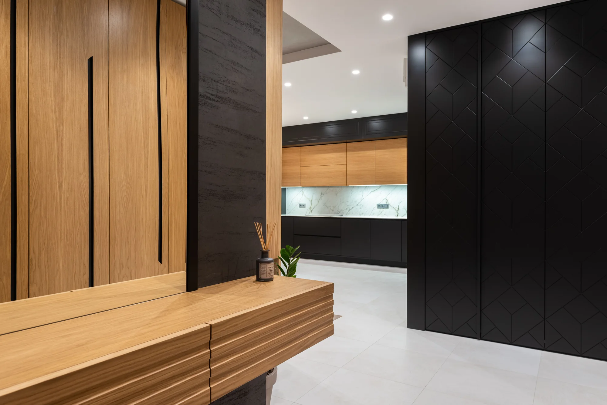 Ebony cabinetry and warm oak surfaces in a modern kitchen