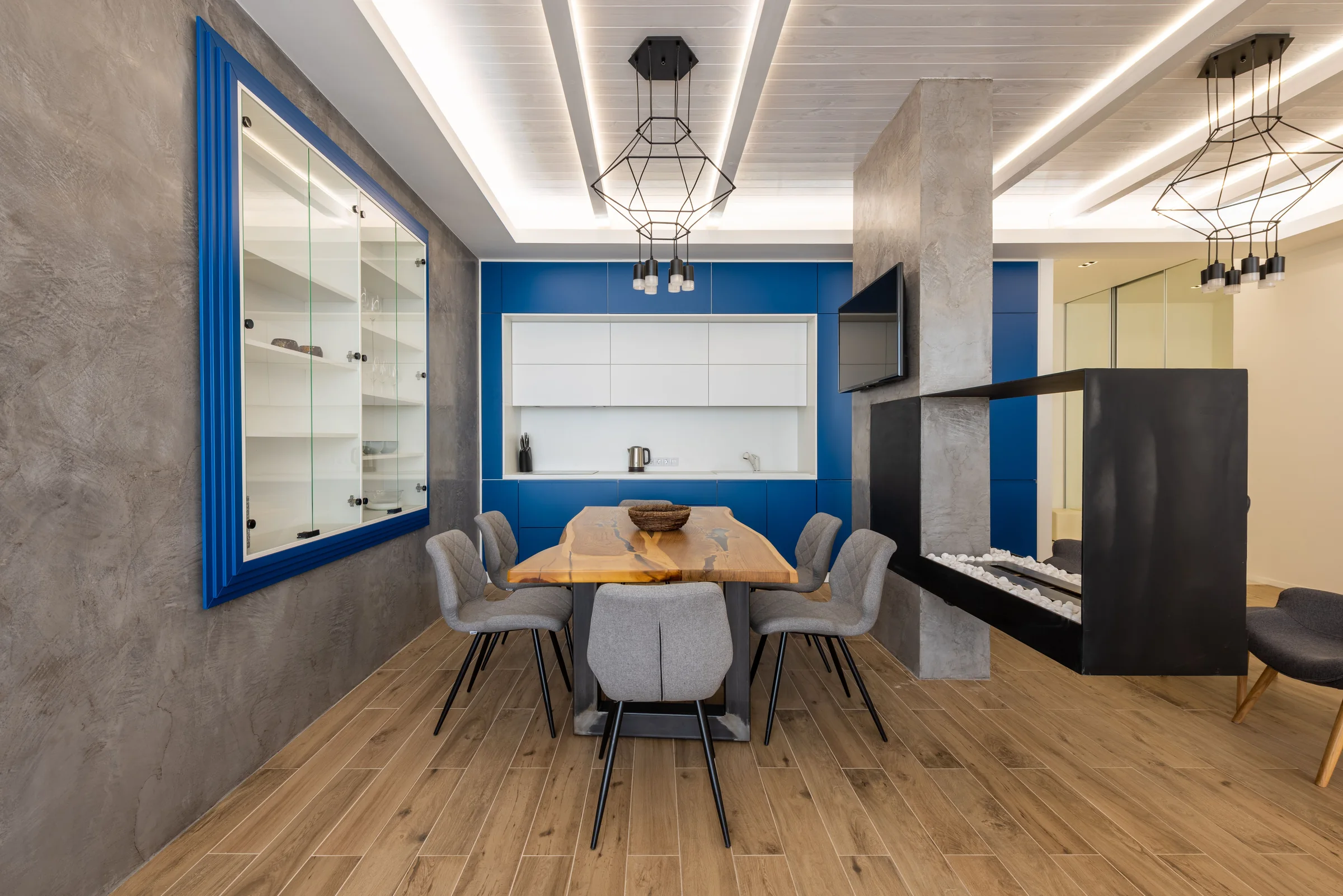 Smoked grey mineral wall with blue cabinetry in SoHo