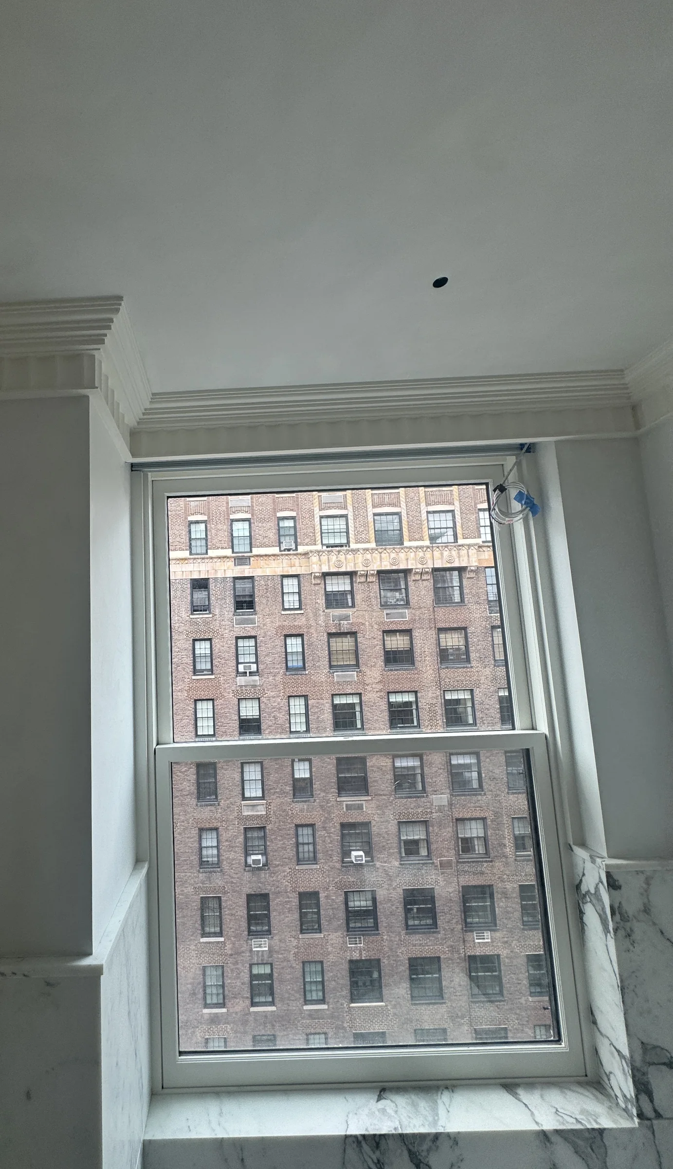Finished ceiling and walls surrounding an Upper East Side window