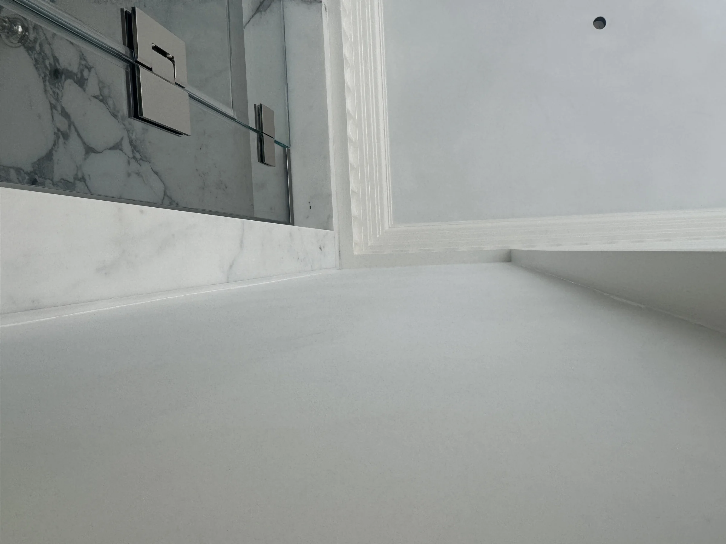 Mineral surface meeting marble and classical trim