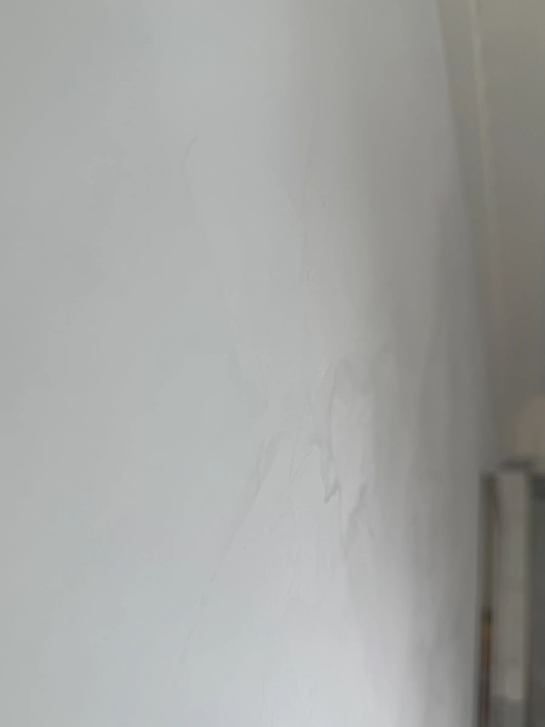 Close detail of the pale hand-applied finish